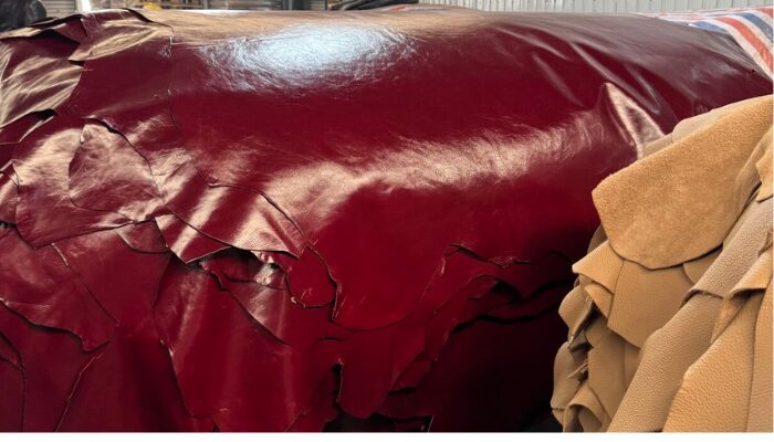 Close-up image of premium full-grain leather sheet showing natural texture and rich brown finish